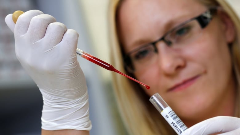 A laboratory technician tests donor blood.