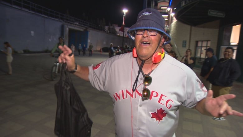 A baseball fan whoops it up and cheers.