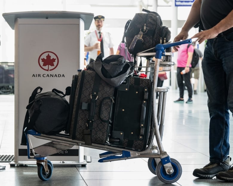 A trolley of luggage is seen at an Air Canada kiosk.