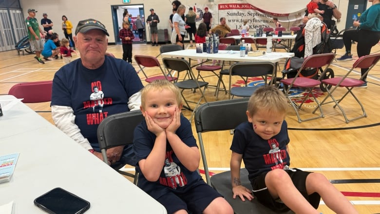 Grandpa and grandkids wearing terry fox run shirts