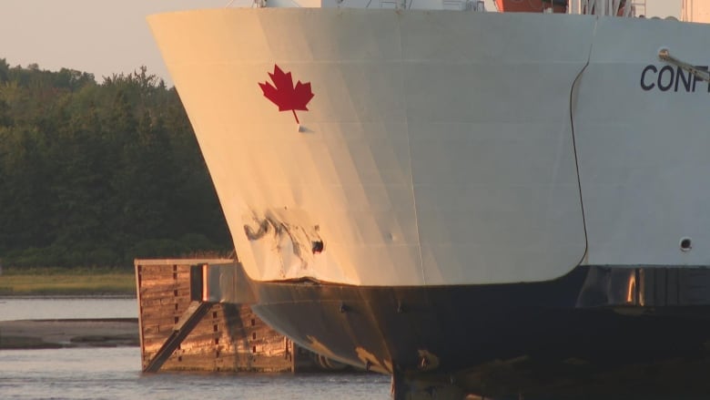 A ferry is parked at dock with visible damage from a collision.