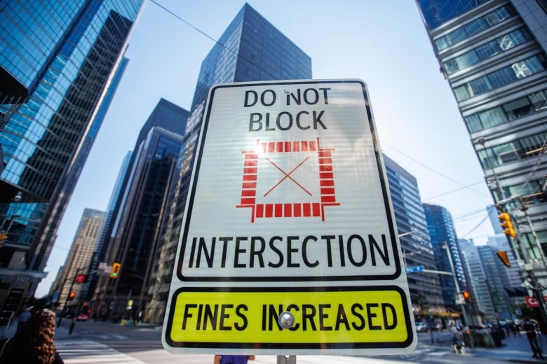 New signage stands against a backdrop of skyscrapers.