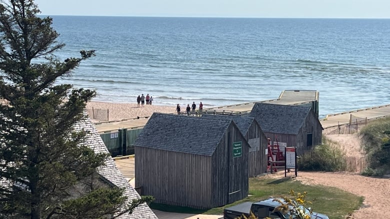 Grey wooden buildings near the coast.