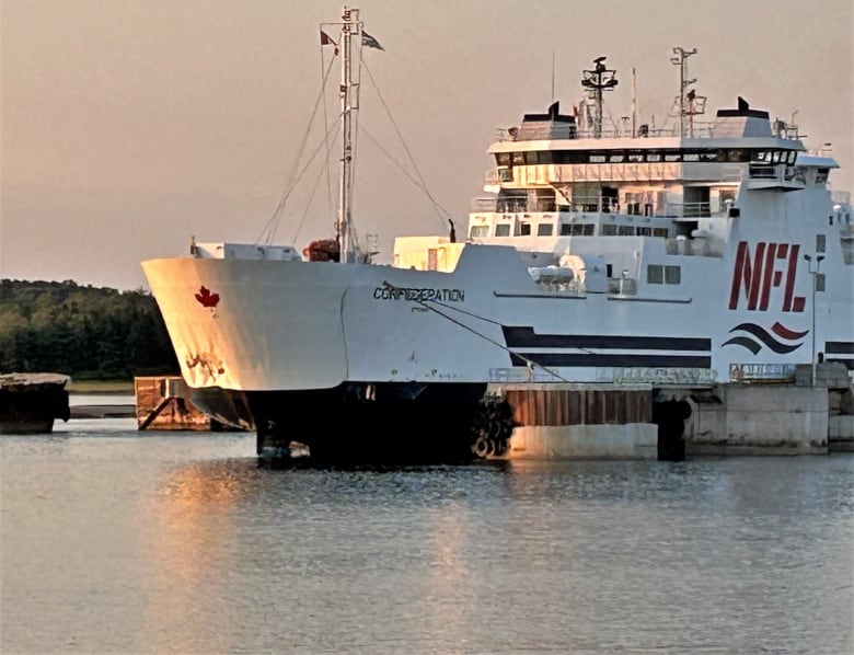 The MV Confederation tied up at the wharf, showing the damage at the bow.