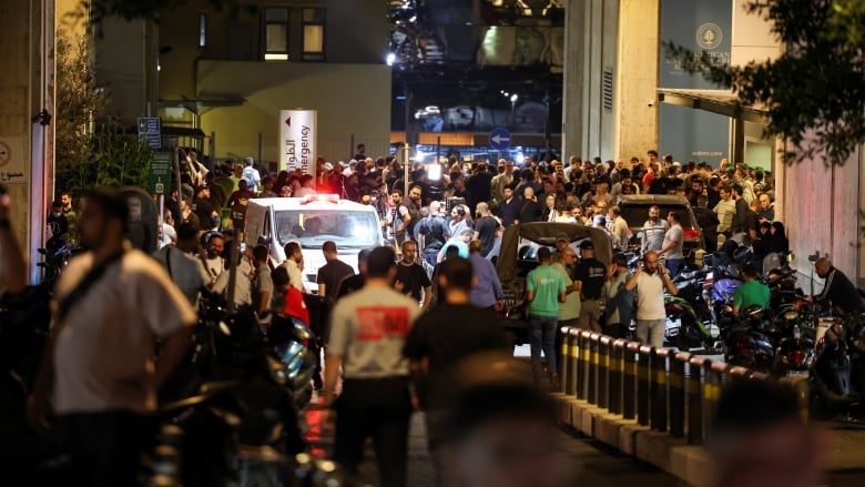 People are seen outside American University of Beirut Medical Center (AUBMC) after more than 1,000 people, including Hezbollah fighters and medics, were wounded when the pagers they use to communicate exploded across Lebanon.