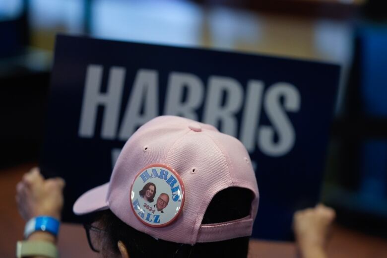 A supporter of Democratic presidential nominee U.S. Vice President Kamala Harris holds up a sign.