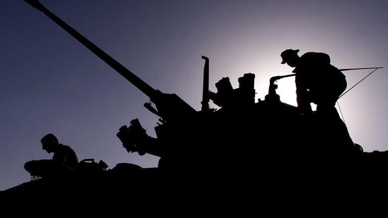 Members of the Lord Strathcona Horse regiment get into a Coyote armoured surveillance vehicle at Kandahar Airbase in Kandahar, Afghanistan Tuesday February 5, 2002. They are part of the initial deployment of a 750-soldier force that is part of Operation Apollo.