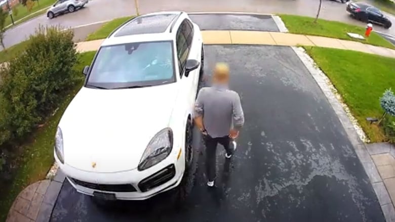 Peel Regional Police say this man was targeted for vehicle theft on Sept. 6 while selling his Porsche SUV on Auto Trader. Moments after this frame grab, security camera footage shows the female driver running over the man as she backs the vehicle onto the street in Mississauga.