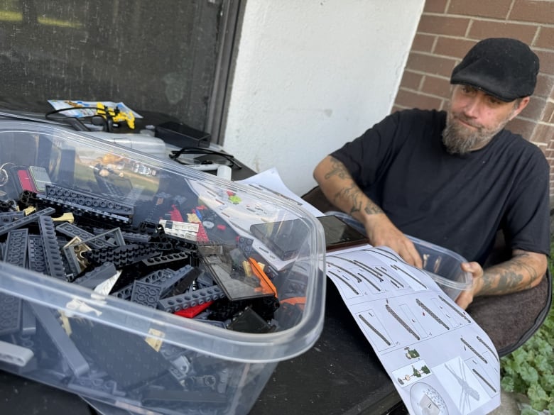 Michael Duke builds his LEGO on his back porch