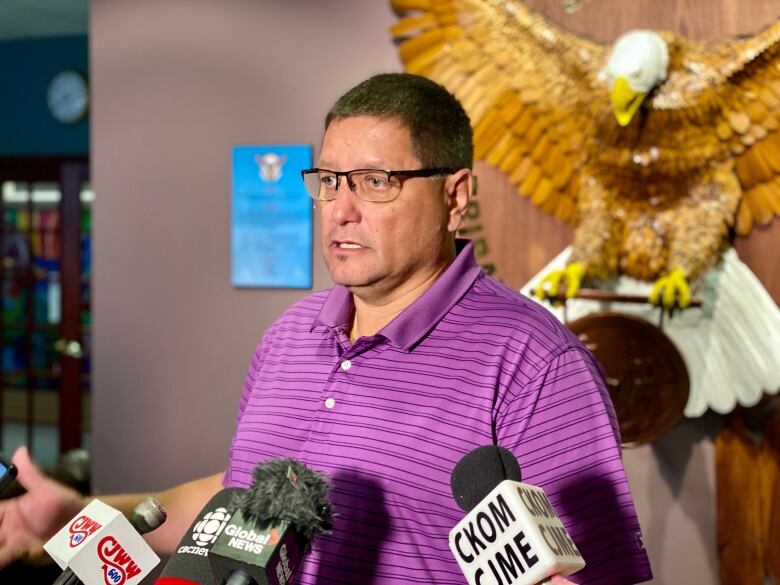 A man in a purple shirt.