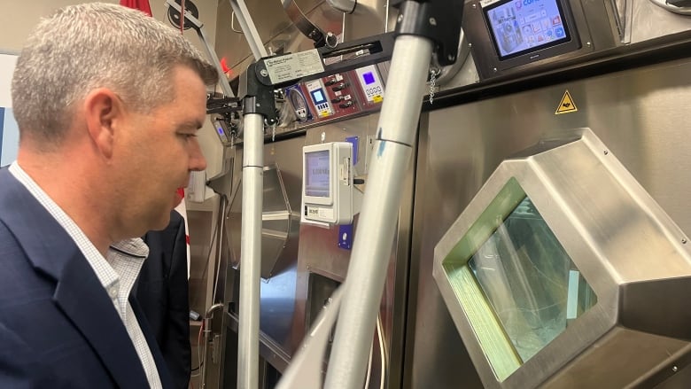 A man looks at scientific equipment.