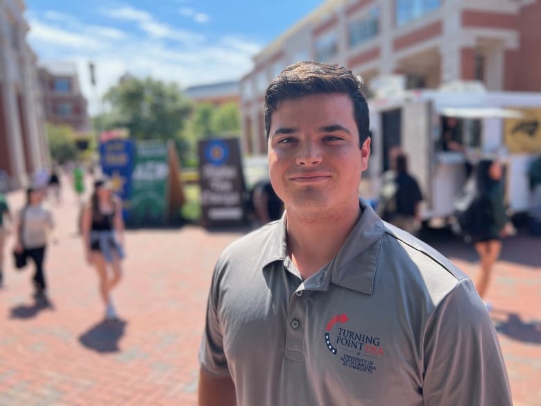 Young man standing on a college campus