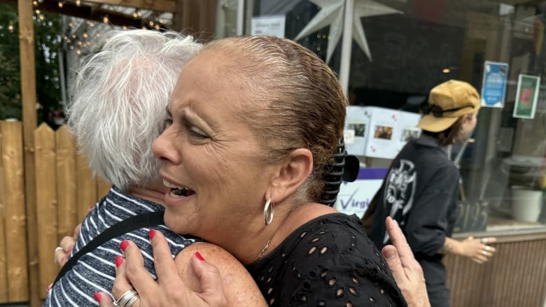 Two women hugging.