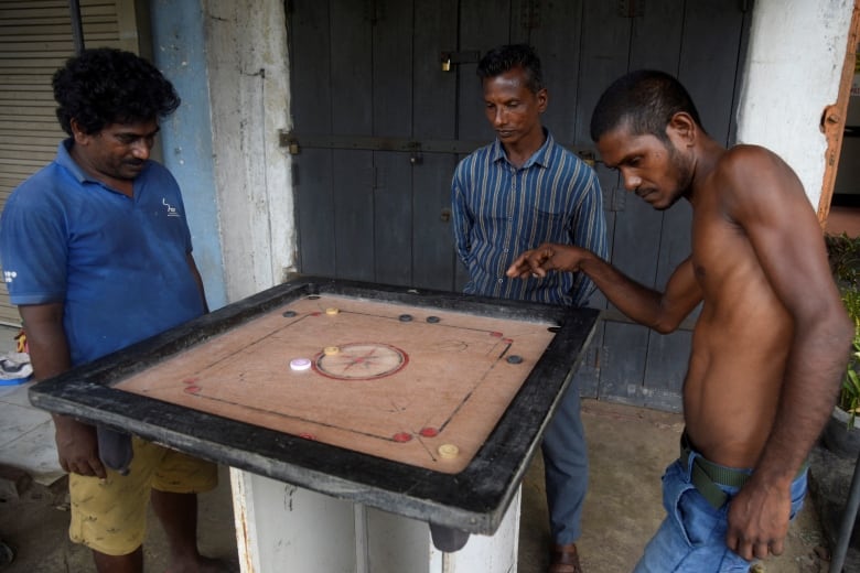 People in Sri Lanka play a game.