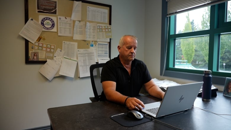 Jeff Virtanen, president of CUPE Local 606, sits at his desk, after putting out a press release expressing concern over EAs having their hours cut. 