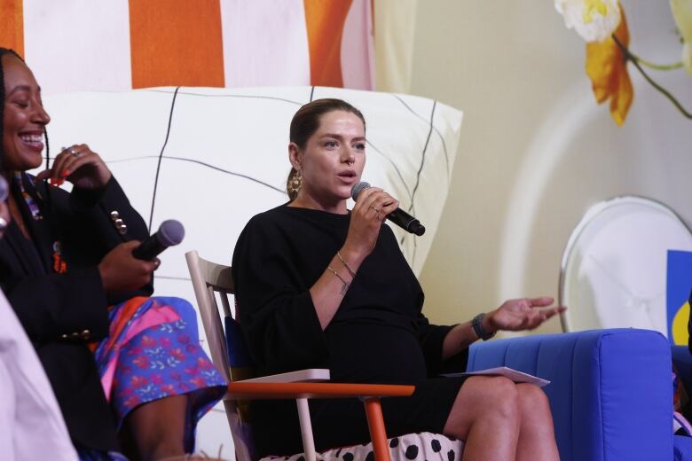 A women speaks into a microphone