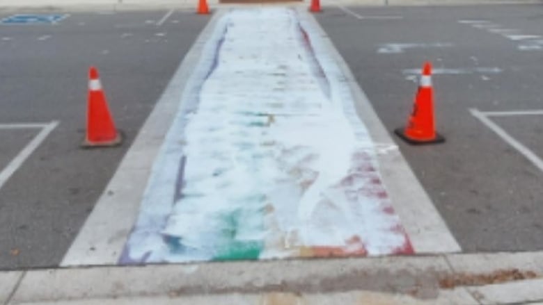 A crosswalk covered in white paint.