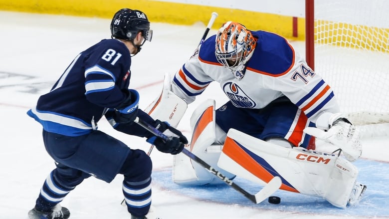 A hockey player scores a goal. 