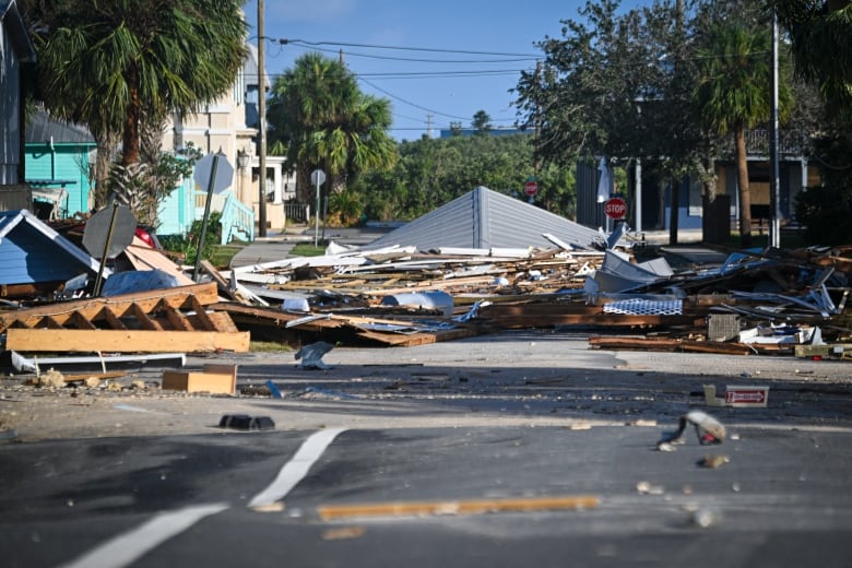 Debris from homes destroyed by Hurricane Helene is seen piled on a street in Cedar Key, Fla., on Friday.