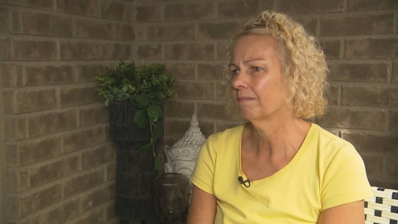 woman sits on porch