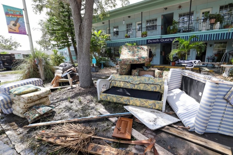 Couches and other household contents are seen on the street in Gulfport, Fla., on Friday, following flooding resulting from Hurricane Helene.