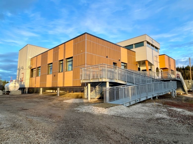 A building with a large walk-up ramp is seen from the outside.