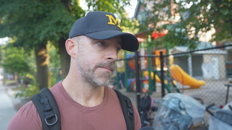 A man gives an interview in front of a daycare.