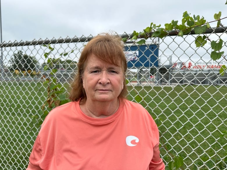 A woman near a football field.