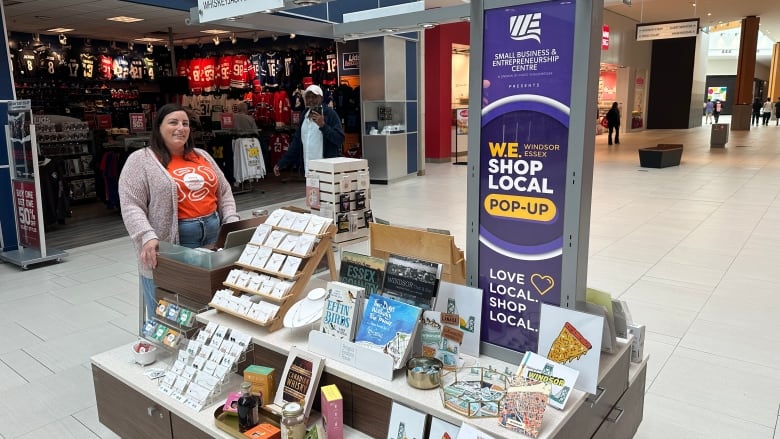 Allie Mistikidis mans the Invest Windsor Essex kiosk at Devonshire Mall with items from her store, Whiskyjack Boutique.