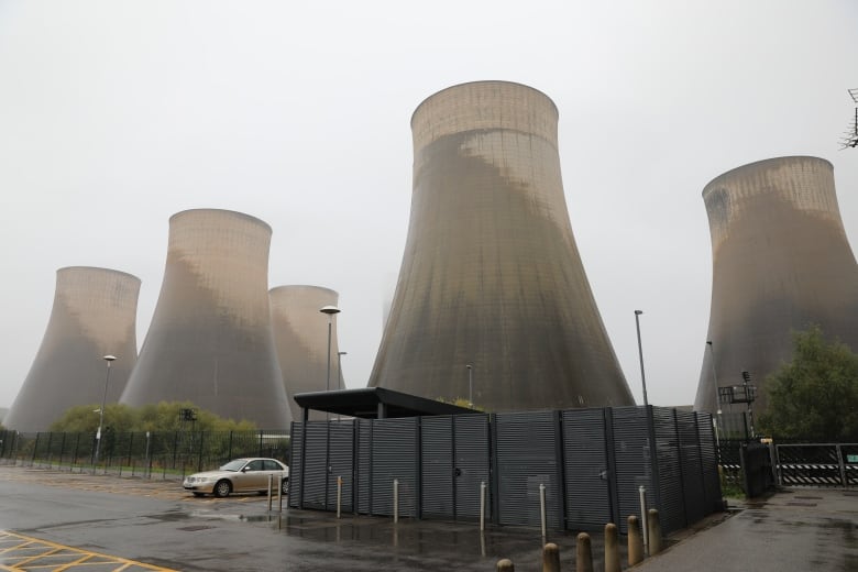 Concrete cooling towers stand on the site of a  coal-fired power station.