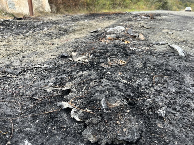 A charred patch of gravel on a trail.