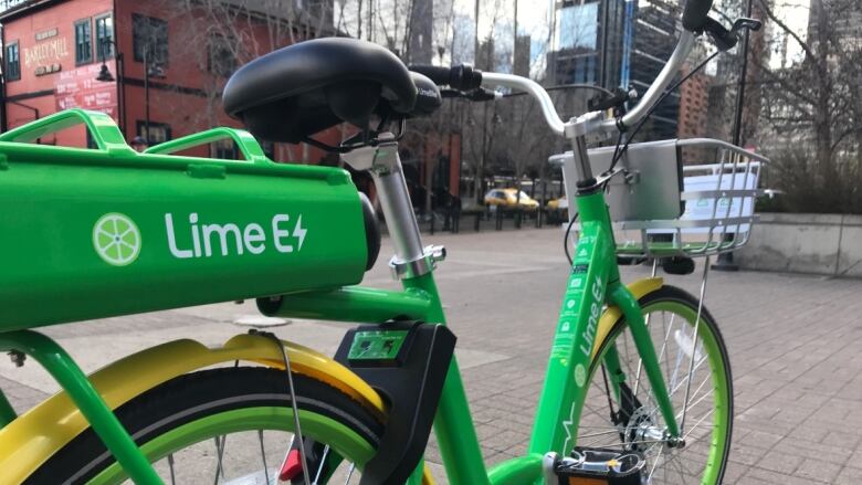 A green bicycle with the words 'Lime E' and an electrical symbol next to the E on its side.