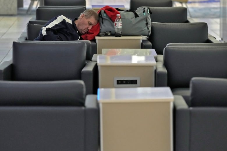 A man sleeps in an airport