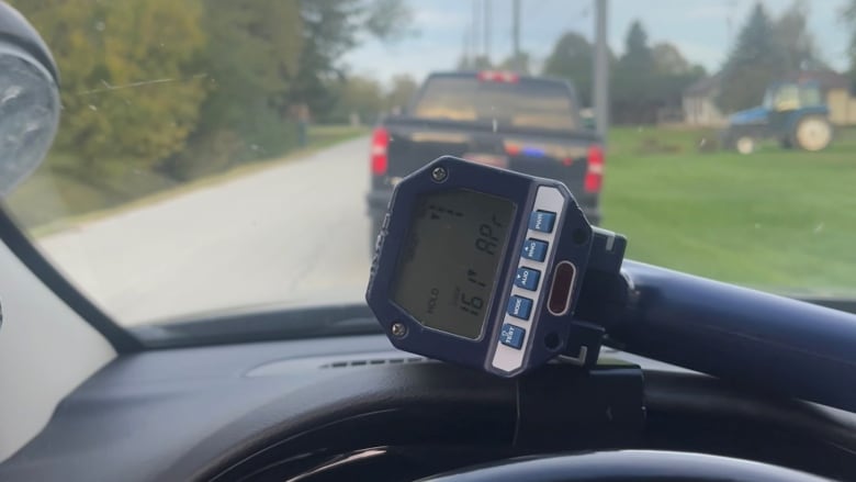 A speed radar on the dash of a police cruiser