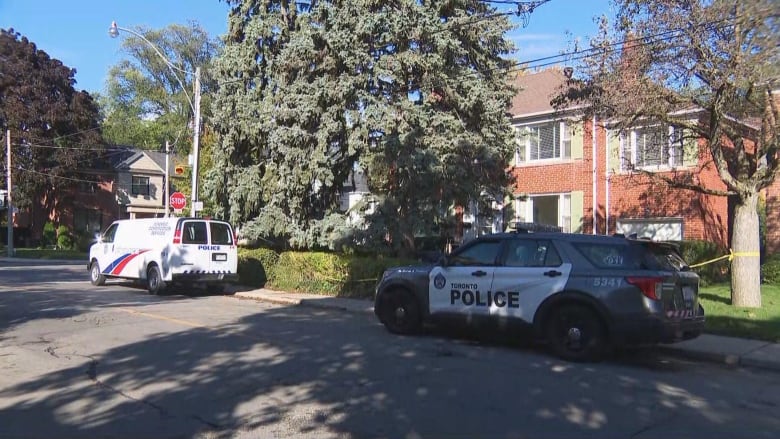 Police cars are parked outside a residence.