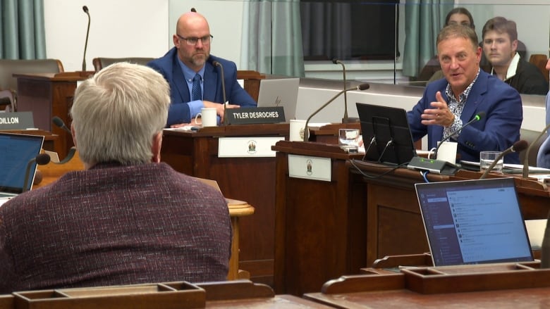 A man in a blue blazer answering a question in the PEI Legislature.