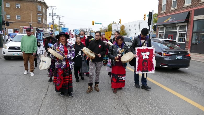 People marching on the street with signs