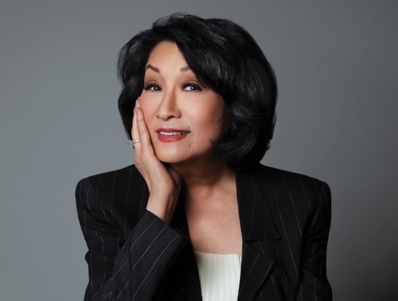 Connie Chung is smiling in front of the camera