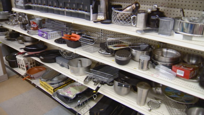 shelves filled with pots, pans and various kitchen items