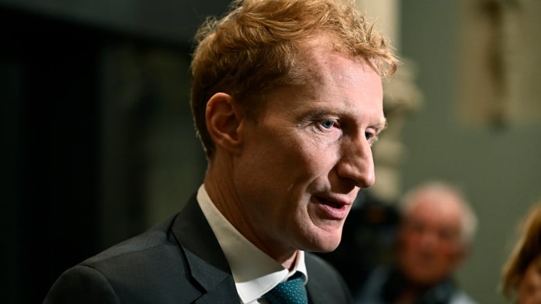 Minister of Immigration, Refugees and Citizenship Marc Miller takes questions from reporters as the Liberal caucus meets on Parliament Hill in Ottawa on Wednesday, Oct. 9, 2024.