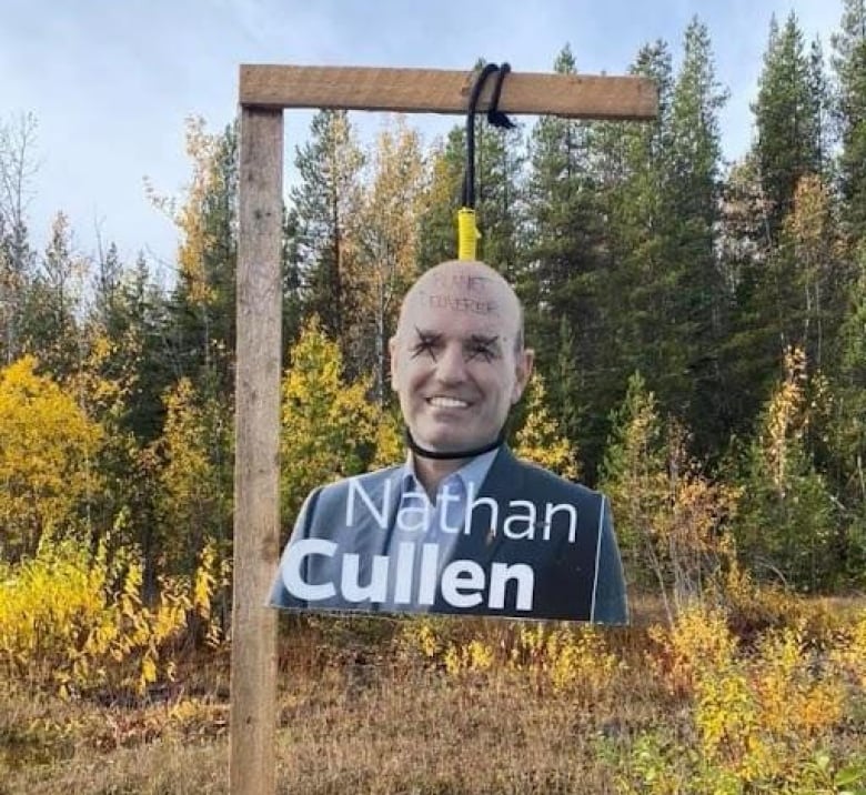 An image stolen from one of BC NDP candidate Nathan Cullen's signs hangs from a makeshift gallows by the side of a highway. 