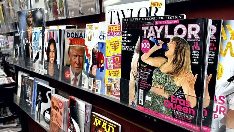 A spread of magazines on a shelf. 