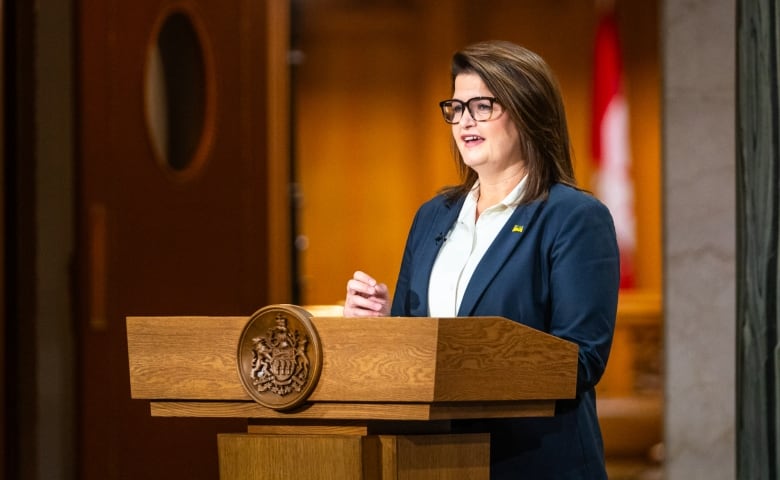 A woman speaks at a podium.