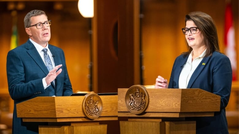 A man and a woman stand at lecterns.