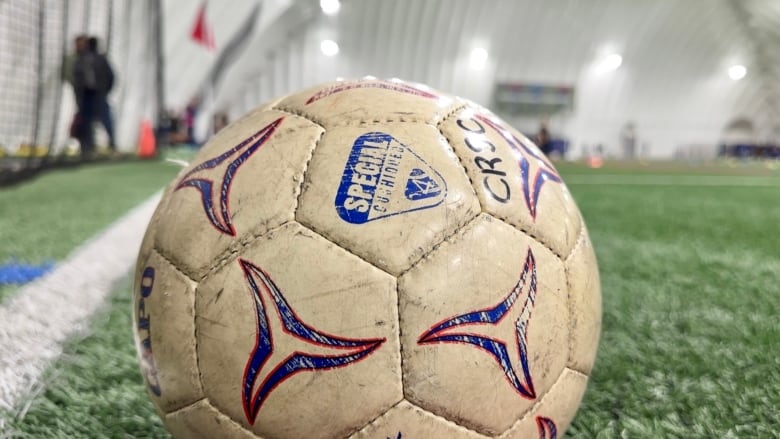 A ball sits on the artifical turf at the Shane Homes West Soccer Centre.