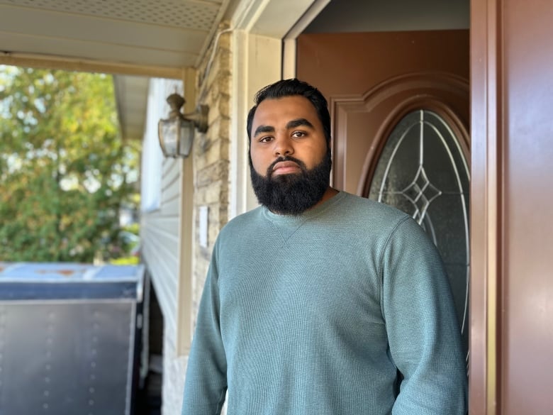 A man standing outside a house