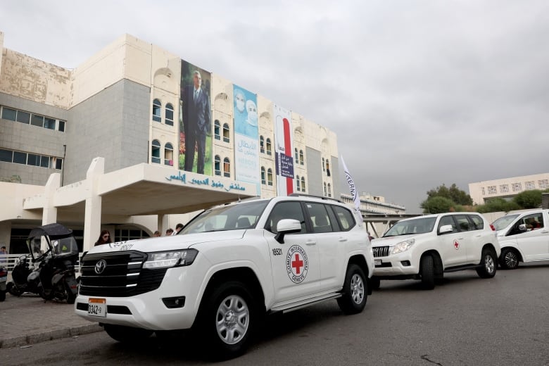 Red Cross vehicles parked in front of a hospital.