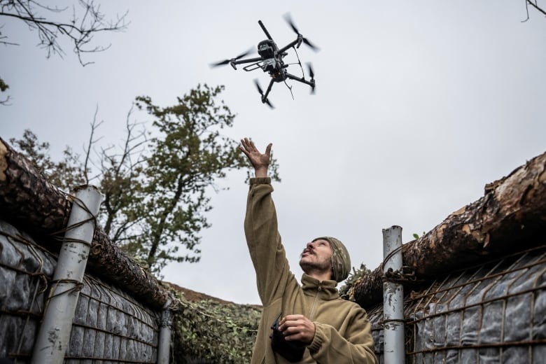 A Ukrainian soldier launches a combat drone near Pokrovsk, in Ukraine's Donetsk region.