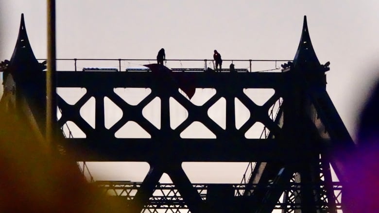 People on a bridge structure. 