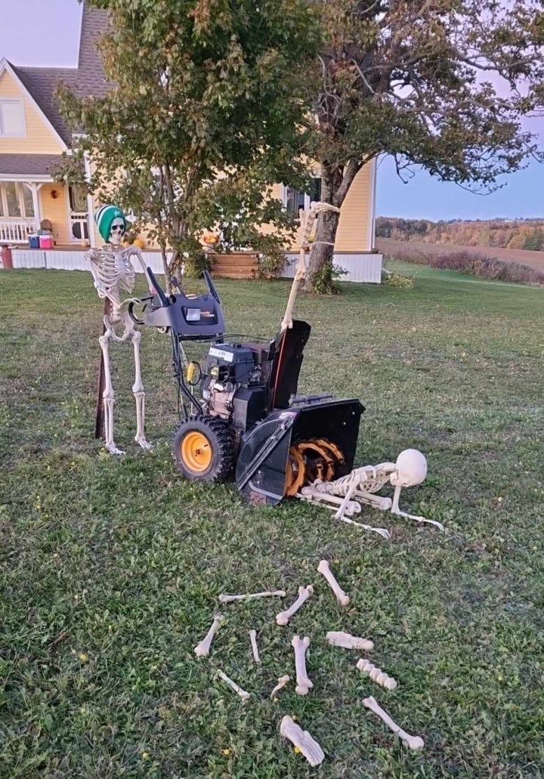 Skeleton pushing a snowblower with bones on the ground.